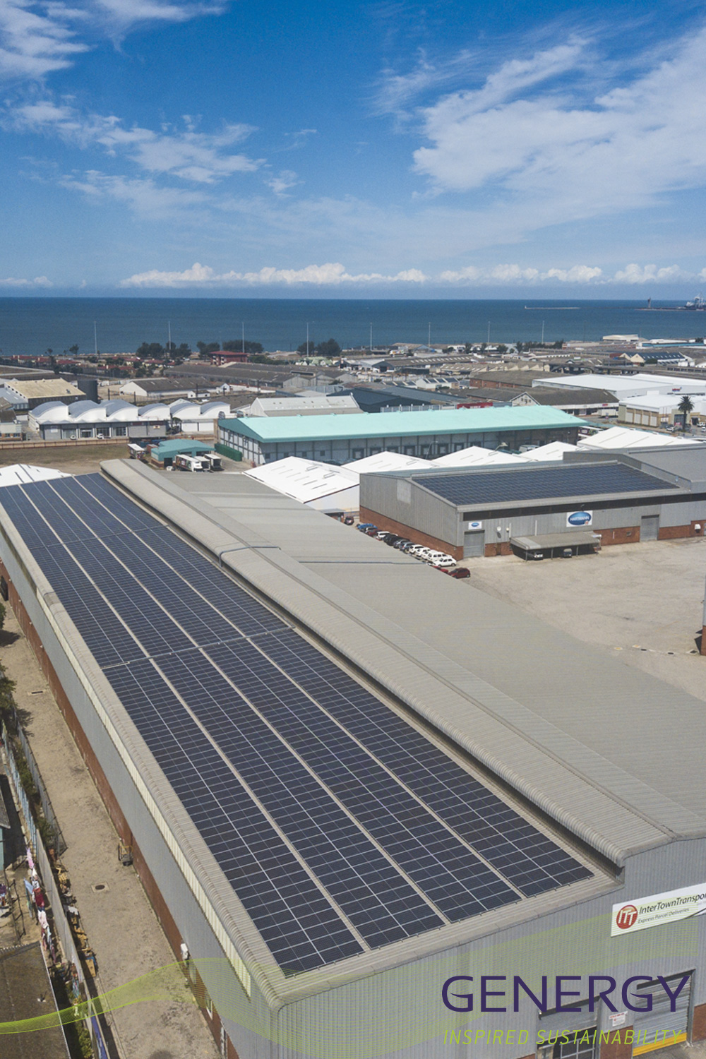 Solar panels on rooftop with sea in background with writing: GENERGY inspired sustainability