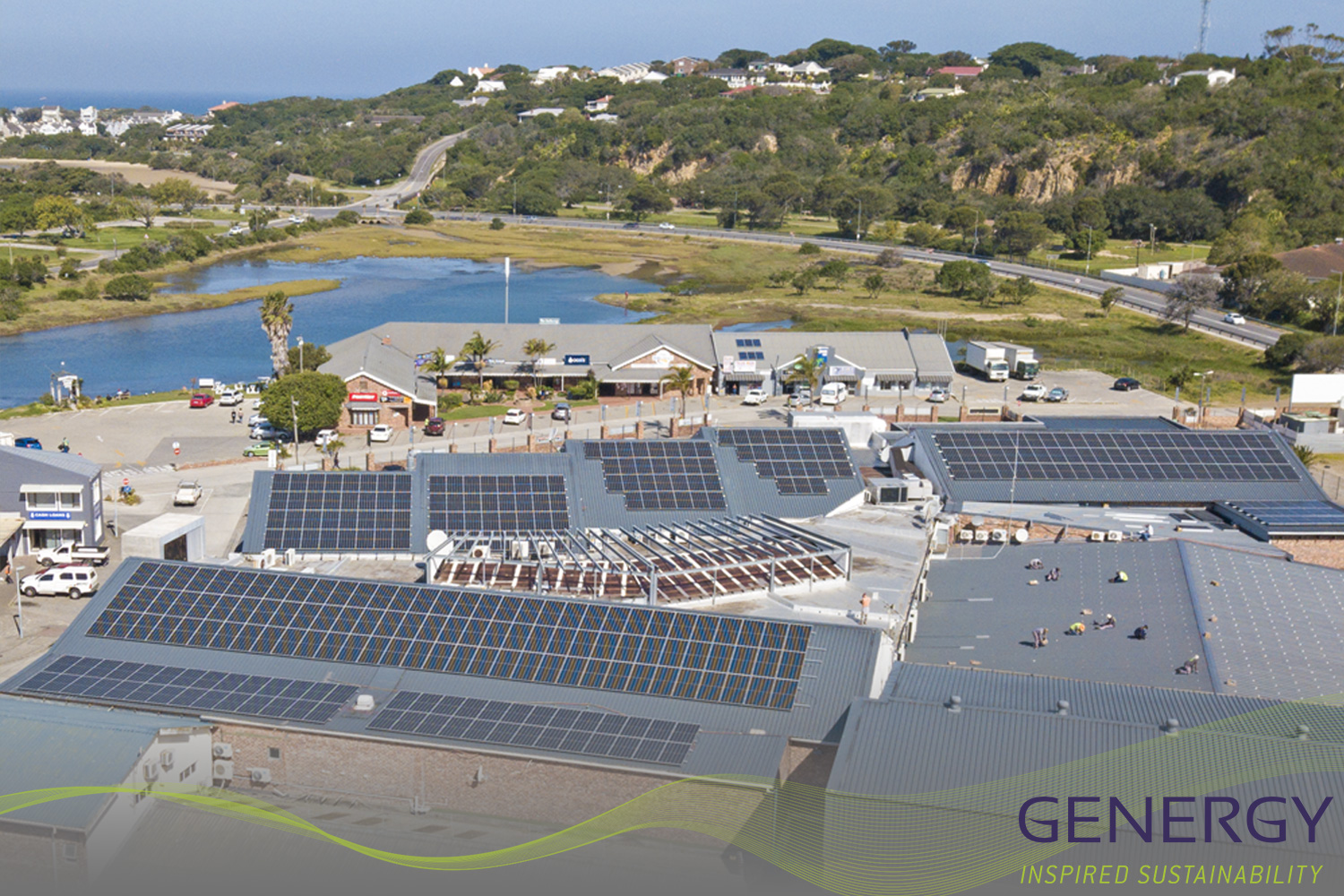 Aerial photo of solar installation with river and nature in background with writing: GENERGY, Inspired Sustainability