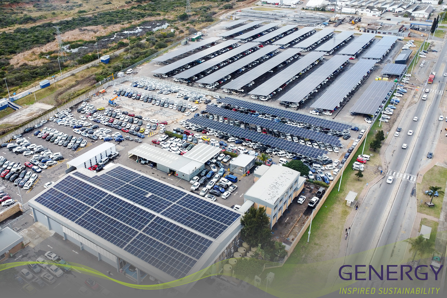 Aerial image of Solar installation on carport with road next to it with green lines at bottom of image and writing in bottom right corner: GENERGY, Inspired sustainability